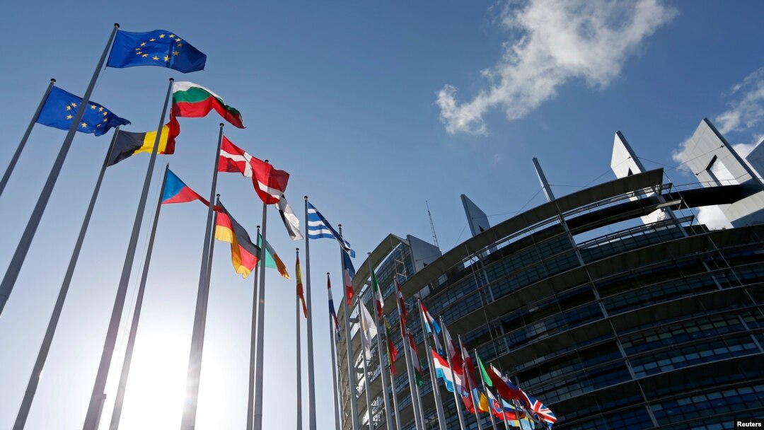 FILE - Flags of European Union member states fly in front of the European Parliament building in Strasbourg, France, April 15, 2014.