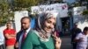 Soumaya Rached Ghannouchi shows her ink-stained finger after voting in the country's first post-revolution parliamentary election on October 26, 2014 in the Tunis suburb of Ben Arous.