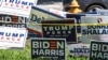 FILE - Trump-Pence and Biden-Harris signs are displayed outside The Coral Gables Branch Library in Miami, Florida, Oct. 27, 2020.
