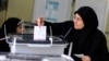 A woman casts her vote at a polling center during a referendum on Egypt's new constitution in Cairo, Jan. 14, 2014. 