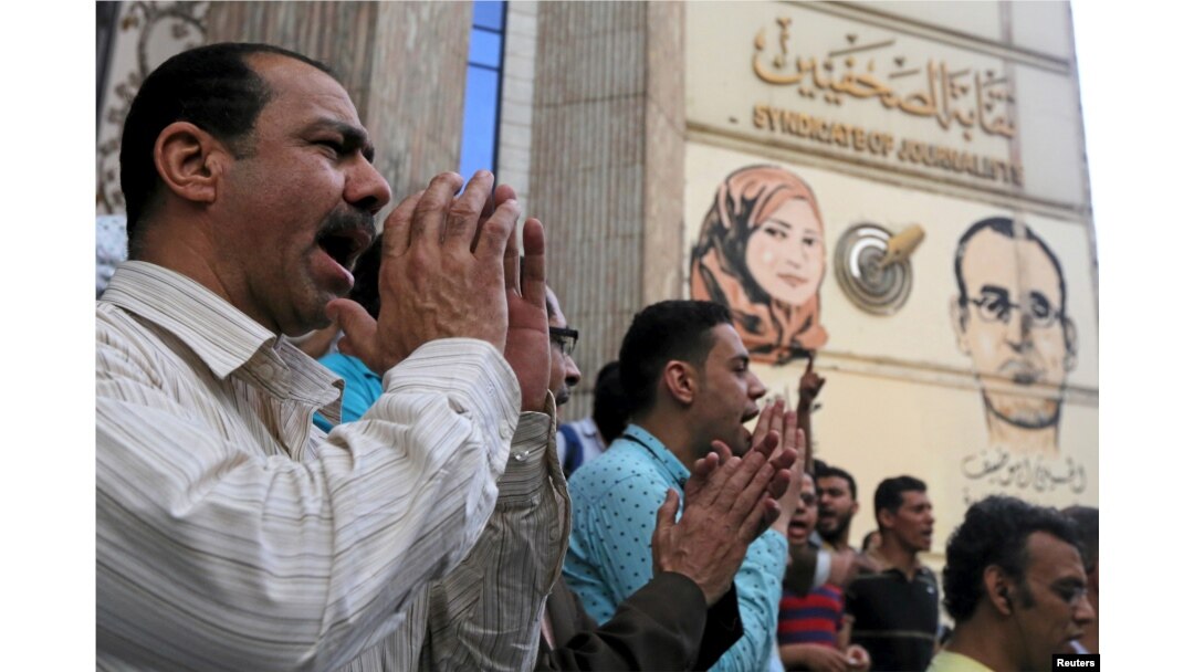 FILE - Journalists and activists protest against the restriction of press freedom and to demand the release of detained journalists, in front of the Press Syndicate in Cairo, Egypt, April 26, 2016.