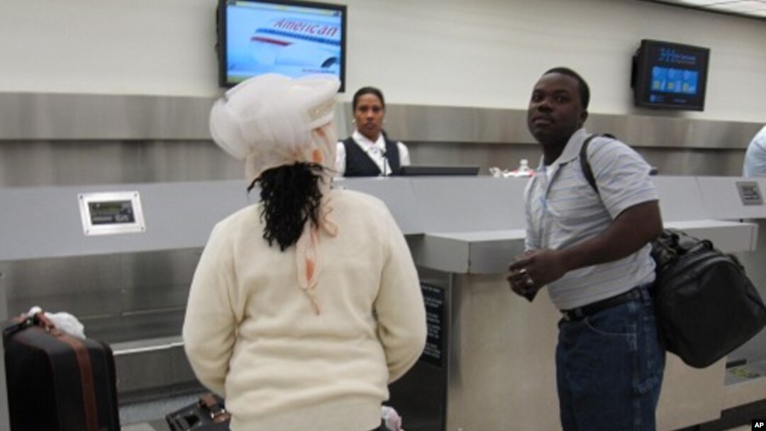 Passengers checking in for American Airlines' first commercial flight out of Miami International Airport since the January 12 earthquake