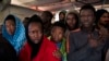 Migrants aboard the Golfo Azurro rescue vessel wait to be transferred to Italian authorities in Trapani harbor, on the Italian island of Sicily, Saturday, April 8, 2017.