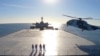 This image made from a video released on Jan. 13, 2021, by the Iranian Army shows a helicopter landing on Makran logistics vessel during a navy drill. 