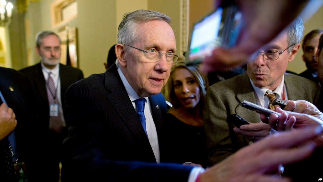 Senate Majority Leader Sen. Harry Reid is surrounded by reporters after leaving the office of Senate Minority Leader Sen. Mitch McConnell on Capitol Hill, Oct. 14, 2013.