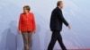 German Chancellor Angela Merkel and Turkey President Recep Tayyip Erdogan go their separate ways after a handshake greeting at the beginning of the G20 summit in Hamburg, Germany, July 7, 2017.