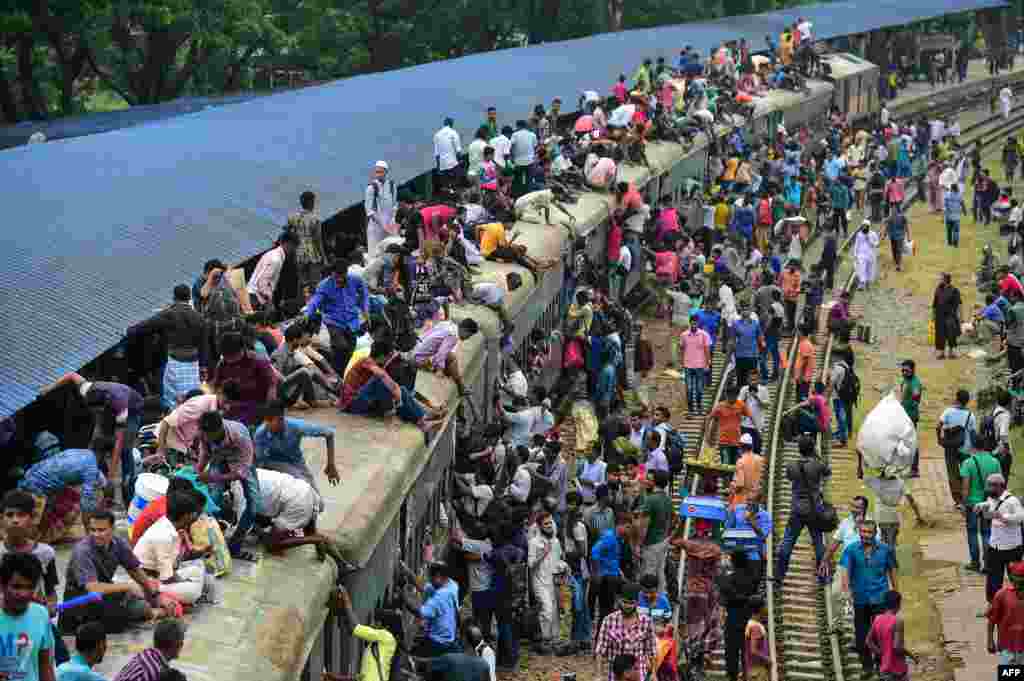 Bangladeshis cram onto a train as they travel home to be with their families ahead of the Muslim festival of Eid al Fitr, in Dhaka.