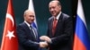 Turkey's President Recep Tayyip Erdogan, right, and Russian President Vladimir Putin shake hands after a joint news conference in Ankara, Turkey, Sept. 28, 2017.