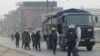 FILE - Cameroonian riot police patrol a street in the port city of Douala, Feb. 25, 2008. Incidents of street justice are growing in Cameroon.