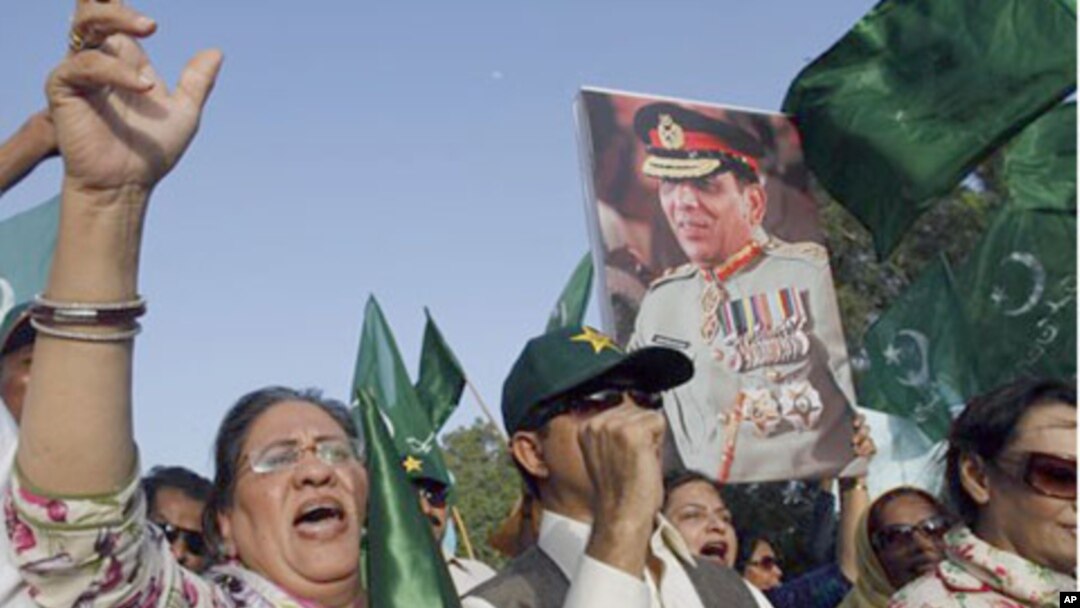 Supporters of political party Pakistan Muslim League hold a picture of army chief Gen. Ashfaq Parvez Kayani in Karachi, Pakistan. Pakistan's intelligence chief, Gen. Ahmed Shuja Pasha, admitted "negligence" on the part of authorities in failing to find bi