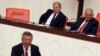 Prime Minister Binali Yildirim, rear right, smiles as he listens to opposition lawmaker Engin Altay before a parliamentary vote in Ankara, Turkey, Sept. 23, 2017. The Turkish parliament renewed a bill allowing the military to intervene in Iraq and Syria if faced with national security threats — a move seen as a final warning to Iraqi Kurds to call off their Monday independence referendum.