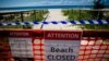 FILE - A closed beach signage is seen at Coolangatta Beach on the Queensland - New South Wales border in Brisbane on April 15, 2020. 