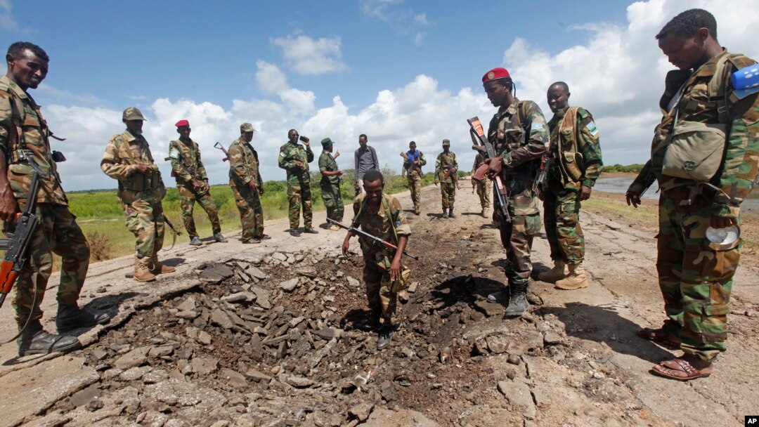 FILE - Somali soldiers stand at a Somali military base, near the site of an attack by al-Shabab, in Lower Juba, June 13, 2018. The base was the target of another al-Shabab assault Monday.