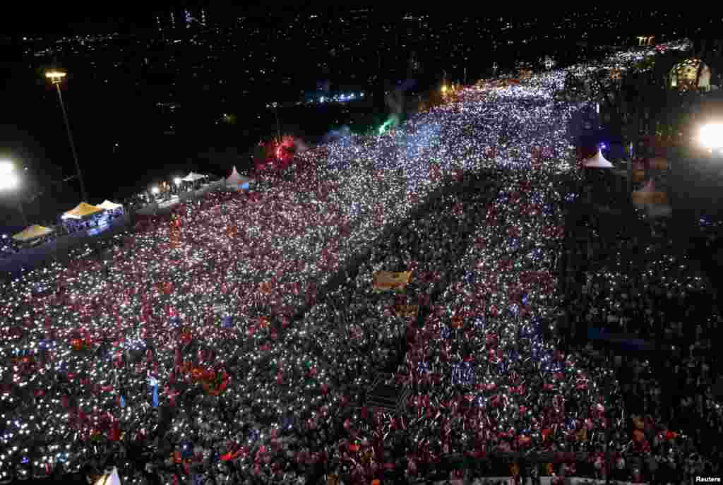 People gather for a ceremony marking the first anniversary of an attempted coup at the Bosporus Bridge in Istanbul, Turkey, July 15, 2017.