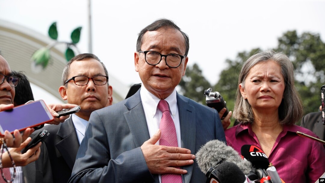 FILE - Cambodia's exiled opposition leader Sam Rainsy, left, speaks to the media as he arrived at Kuala Lumpur International's Airport in Sepang, Malaysia, Nov. 9, 2019. 