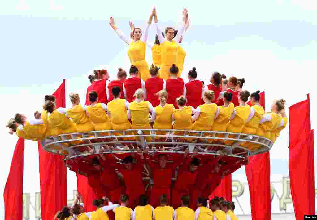People perform after a military parade to mark the Independence Day in Minsk, Belarus.