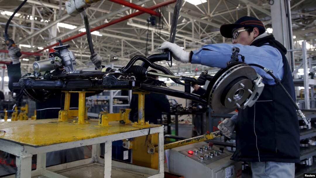 An employee works on an assembly line producing electronic cars at a factory of Beijing Electric Vehicle, funded by BAIC Group, in Beijing, China, Jan. 18, 2016. 