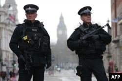 Armed police officers secure the area near the Houses of Parliament in central London on March 23, 2017 the day after the March 22 terror attack in Westminster claimed at least three lives.