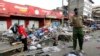 A policeman secures the scene of twin explosions at the Gikomba open-air market for second-hand clothes in Kenya's capital Nairobi, May 16, 2014.