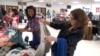 A high school cafeteria in Springfield, Virginia is the site of a large clothing swap, where over 300 attendees participated. 