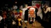 Children and their families stand outside the Mediclinic Heart Hospital where former South African President Nelson Mandela is being treated in Pretoria, South Africa, June 26, 2013.