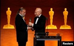 Actor Patrick Stewart, right, presents Jonathan Erland with the Gordon E. Sawyer Award at the Scientific and Technical Awards in Beverly Hills, California, Feb. 10, 2018.
