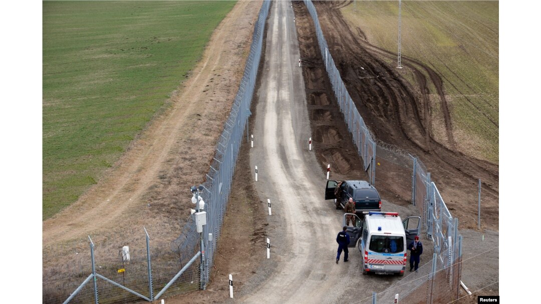Hungarian police and soldiers patrol the Hungary-Serbia border, which was recently fortified by a second fence, near the village of Gara, Hungary, March 2, 2017.