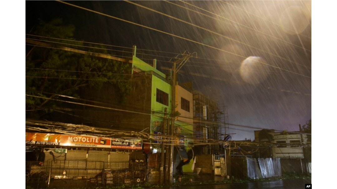 Strong winds and rain batter buildings and business establishments as Typhoon Mangkhut hits Tuguegarao city, Cagayan province, northeastern Philippines, Sept. 15, 2018. Typhoon Mangkhut slammed into the country's northeastern coast early Saturday.