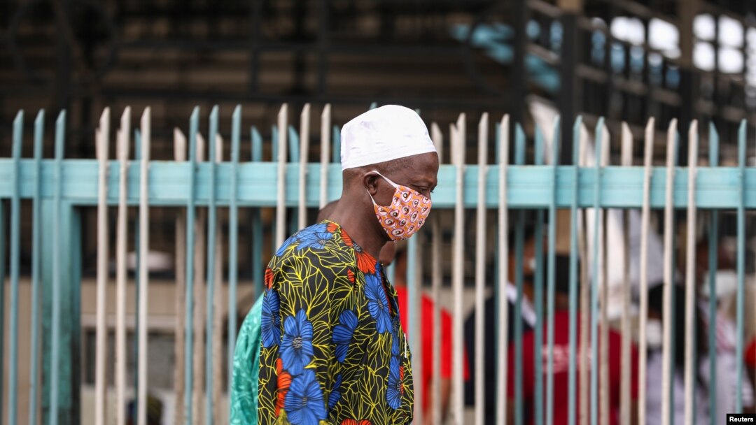 FILE - A man wearing a protective face mask is seen on the first day of the easing of coronavirus lockdown measures, in Lagos, Nigeria, May 4, 2020.