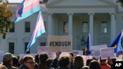 FILE - Members of the Human Rights Campaign and other LGBTQ activists gather on Pennsylvania Avenue in front of the White House in Washington, Oct. 22, 2018.