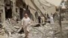 This undated frame grab from video posted online May 29, 2017, by the Aamaq News Agency, a media arm of the Islamic State group, shows people inspecting damage from airstrikes and artillery shelling in the northern Syrian city of Raqqa, the de facto capital of IS.
