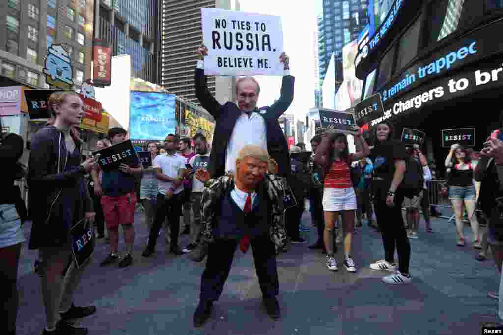 A participant dressed as both Russia's President Vladimir Putin and U.S. President Donald Trump attends a protest against Trump's announcement that he plans to reinstate a ban on transgender individuals from serving in any capacity in the U.S. military, in Times Square, New York, July 26, 2017.