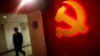A trainee walks pass a communist party logo as he attends a training course at the communist party school called China Executive Leadership Academy, Sept. 2012.