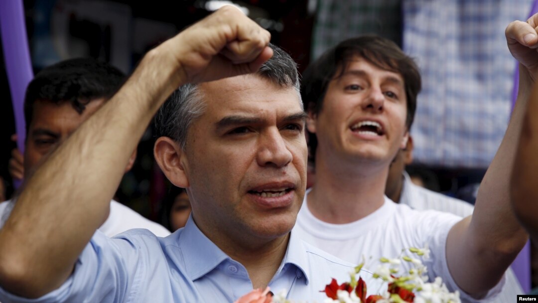 FILE - Peruvian presidential candidate Julio Guzman greets supporters during a rally at a market in the San Juan de Lurigancho district of Lima, Jan. 20, 2016.