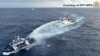This handout taken and released on December 4, 2024 by the National Task Force for the West Philippine Sea (NTF-WPS) shows a China coast guard ship, right, deploying a water cannon at a Philippine Bureau of Fisheries and Aquatic Resources vessel.