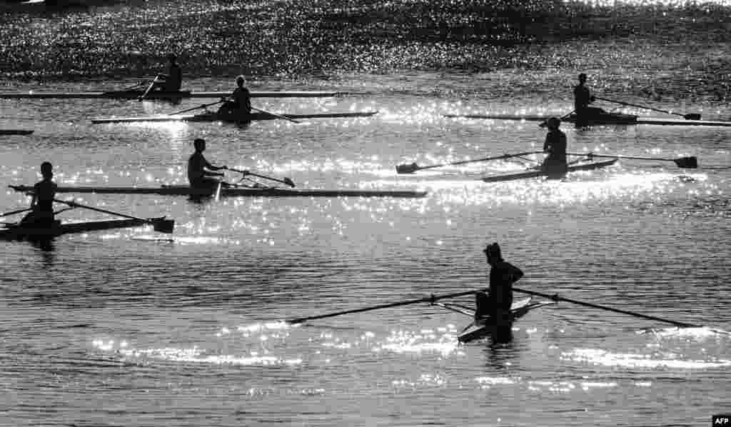 Rowers take part in a training session on the Isebek canal in Hamburg, Germany.