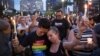 Jennifer, right, and Mary Ware hold up candles during a vigil downtown for the victims of a mass shooting at the Pulse nightclub in Orlando, Florida, June 13, 2016.