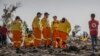 FILE - Investigators from Israel examine wreckage on March 12, 2019, at the scene of the Ethiopian Airlines Boeing 737 Max 8 crash near Bishoftu, or Debre Zeit, south of Addis Ababa, in Ethiopia.