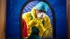 FILE -A healthcare worker dons protective gear before entering an Ebola treatment center in the west of Freetown, Sierra Leone,Oct. 16, 2014..