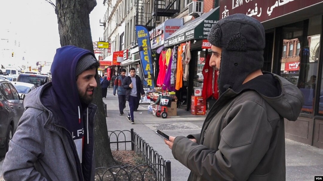 Yemeni-American Ali Abdul (left) and Mohammed Ghaleb, a permanent resident from Yemen, chat following afternoon prayer at Masjid al-Farooq, in Brooklyn, NY. (R. Taylor/VOA)