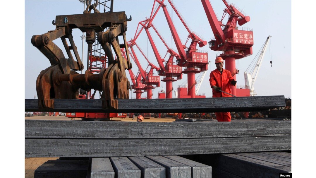 FILE - A worker loads steel bars for export at a port in Lianyungang, Jiangsu province, China, June 4, 2013.
