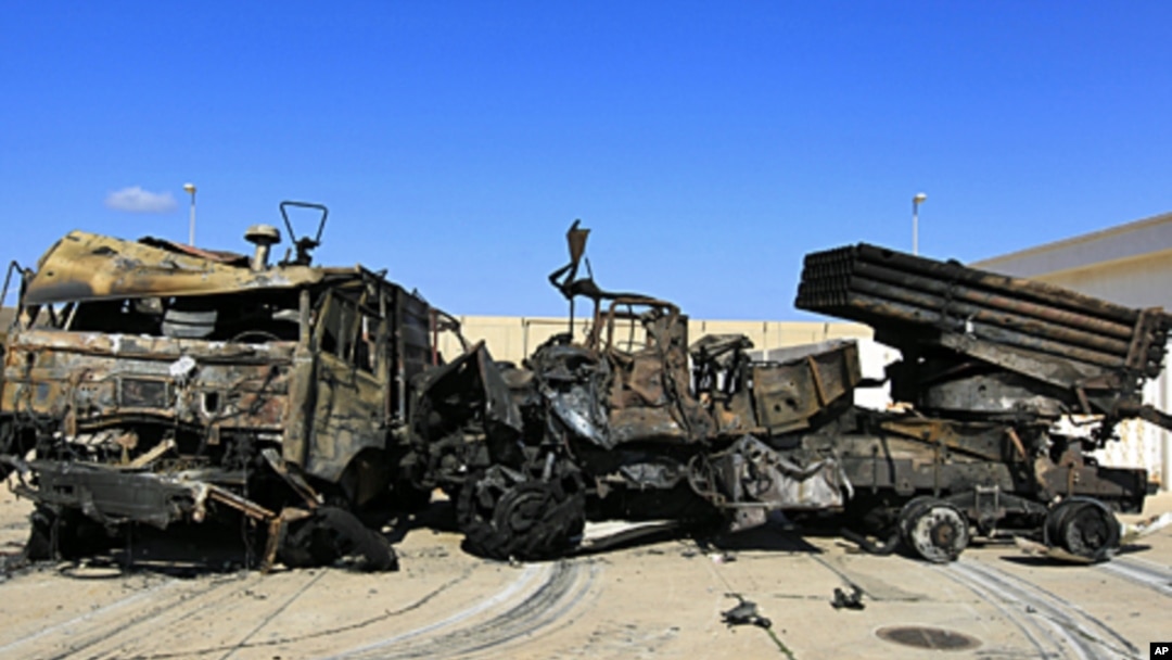 Destroyed military vehicles are seen at a naval military facility after coalition air strikes in eastern Tripoli, March 22, 2011