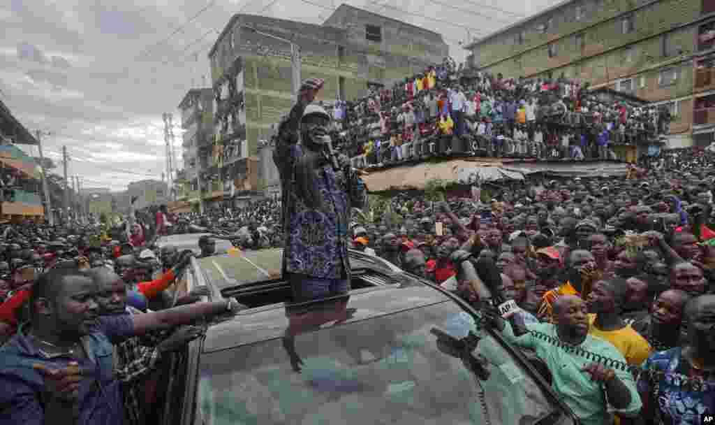 Kenyan opposition leader Raila Odinga speaks to thousands of supporters gathered in the Mathare area of Nairobi. Odinga condemned police killings of rioters during protests after the country's disputed election and is urging supporters to skip work Monday.