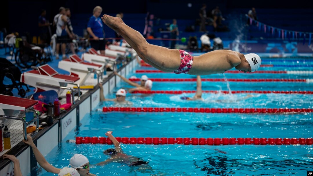 Yuan Weiyi, from China, jumps into the pool during a training session ahead of the 2024 Paralympics, Aug. 27, 2024, in Paris, France.