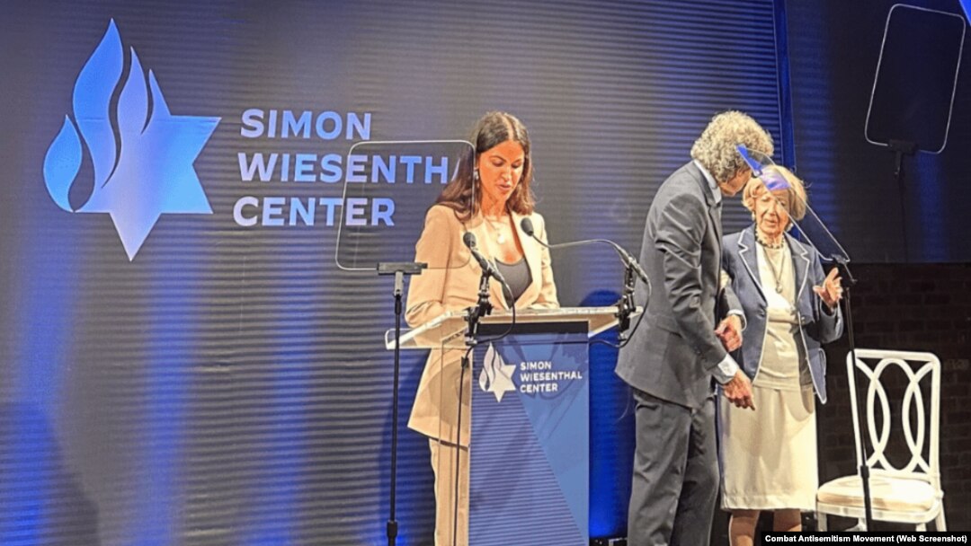 FILE - A survivor of Hamas' Oct. 7, 2023 terror attack, Natalie Sanandaji, left, accepts the Simon Wiesenthal Center's Medal of Valor and another award in New York, Sept. 12, 2024. She participated in a video made to demonstrate solidarity with Iranian women resisting oppression.