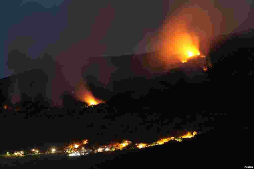 Forest fires are seen in Lustica peninsula near Tivat, Montenegro, Aug. 1, 2017.