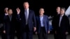 President Donald Trump speaks as he stands with Tony Kim, second left, Kim Dong Chul, center right, and Kim Hak Song, right, three Americans detained in North Korea for more than a year, after they arrived at Andrews Air Force Base in Md., May 10, 2018. 