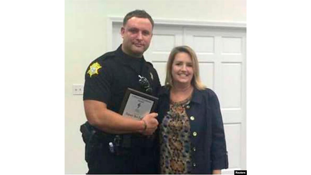 Richland County Sheriff's Department Officer Senior Deputy Ben Fields, left, is pictured with Lonnie B. Nelson Elementary School Principal Karen Beaman after receiving Culture of Excellence Award, in Columbia, S.C., Nov. 12, 2014.