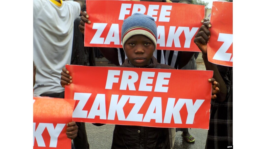 FILE - Protesters from the pro-Iranian Islamic Movement of Nigeria (IMN) carry banners during a march in the streets to press for the release of their leader, Ibrahim Zakzaky, in the northern Nigerian city of Kano, Aug. 11, 2016.