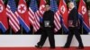 U.S. President Donald Trump and North Korea's leader Kim Jong Un walk during their summit at the Capella Hotel on Sentosa island in Singapore, June 12, 2018.